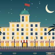 A grand hotel on the seafront at dusk, under a crescent moon.
