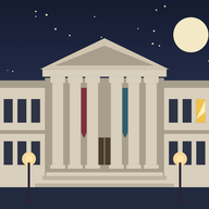 A museum with a columned front at night.